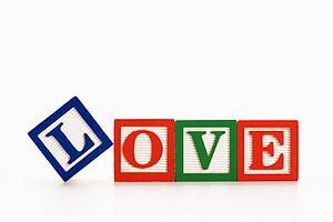 Alphabet toy building blocks spelling the word love.