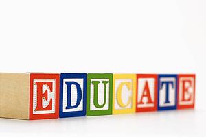 Alphabet toy building blocks spelling the word educate.