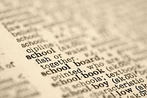 Selective focus of dictionary definition for the word school.