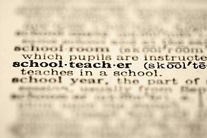 Selective focus of dictionary definition for the word schoolteacher