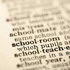Selective focus of dictionary definition for the word schoolroom 
