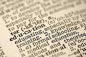 Selective focus of dictionary entry for the word education.