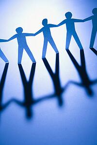 Cutout paper men standing holding hands