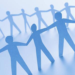 Cutout paper men standing holding hands