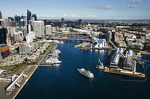 Aerial view of ships and boats in Darling Harbour with view of skyscrapers in Sydney, Australia