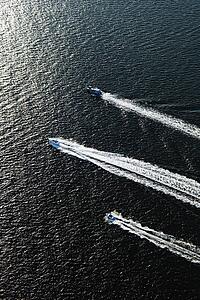 Aerial view of three boats traveling together in Sydney, Australia.