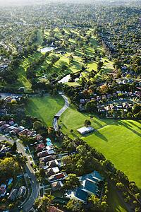 Aerial view of Ryde Parramatta Golf Course and buildings in West Ryde, Australia