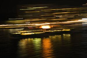 Blurred lights at night reflected on Sydney Harbour in Sydney, Australia