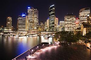 Cityscape of Sydney, Australia with harbor and buildings at night