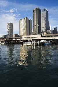 Circular Quay Railway Station in Sydney Cove with view of downtown skyscrapers in Sydney, Australia.