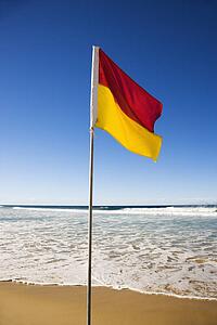 Red and yellow flag on beach in Surfers Paradise, Australia