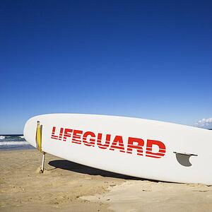 Lifeguard surfboard on beach in Surfers Paradise, Australia.