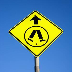 Pedestrian crosswalk sign with blue sky in Australia