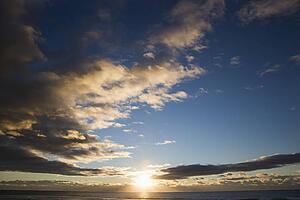 Cumulus clouds at sunset over ocean in Surfers Paradise, Australia.