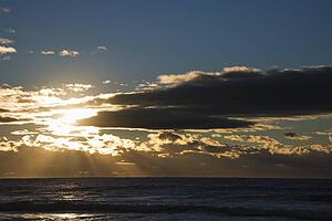Cumulus clouds at sunset over ocean in Surfers Paradise, Australia