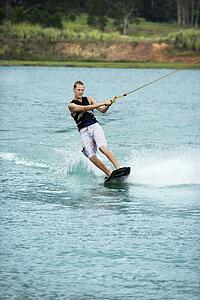 Male wakeboarding on lake