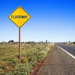 Floodway sign by road in rural Australia.