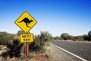 Kangaroo crossing sign by road in rural Australia