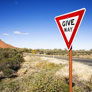 Humorous road sign reading Give Way in rural Australia.