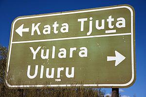 Road sign with direction to Kata Tjuta and Yulara Uluru in Uluru Kata Tjuta National Park, Australia