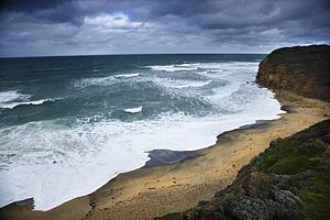 Coastline with waves and rocky shore as seen from Great Ocean Road in Australia