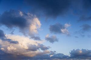 Colorful cumulus clouds in sky.