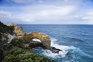 Rock in arch shape on coastline of Australia as seen from Great Ocean Road.