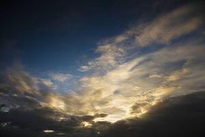 Backlit clouds in blue sky