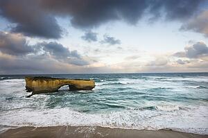 Rock formation forming arch on coastline of Great Ocean Road, Australia