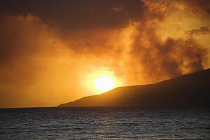 Maui, Hawaii sunset with ocean and island mountain on Maui, Hawaii.