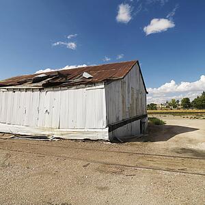 Dilapidated building with old train tracks.