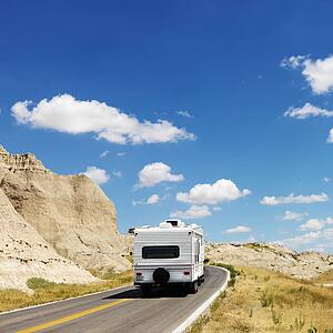 Recreational vehicle on scenic road in Badlands National Park, North Dakota.