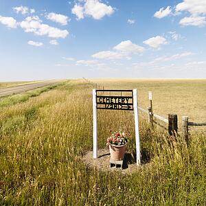 Roadside sign indicating directions to rural cemetery.