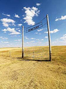 Entrance with sign for rural cemetery.