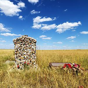 Headstone and grave marker in field