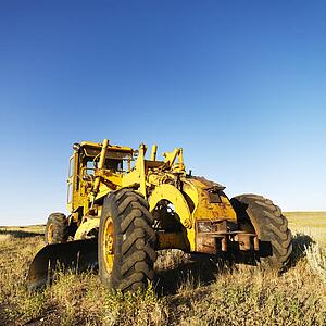 Yellow tractor in field. 