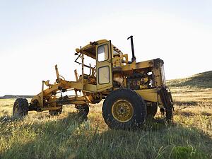Yellow tractor in field. 