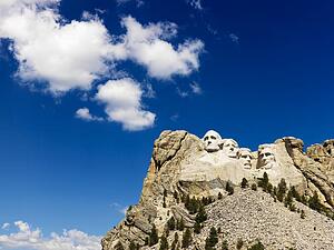 Mount Rushmore National Memorial with blue cloudy sky
