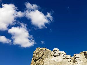 Mount Rushmore National Memorial with blue cloudy sky