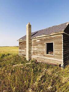 Abandoned wooden house in state of disrepair in rural countryside
