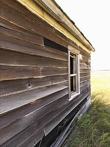 Side of abandoned wooden dilapidated house