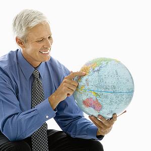 Man pointing on globe