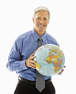 Man holding globe and smiling