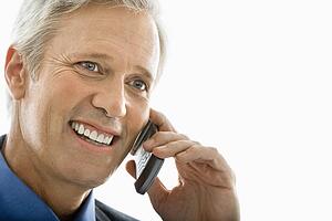 Man smiling and talking on cell phone