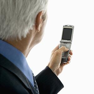 Back view of middle aged man looking at cell phone