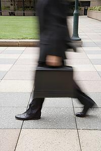 Businessman walking outdoors with briefcase