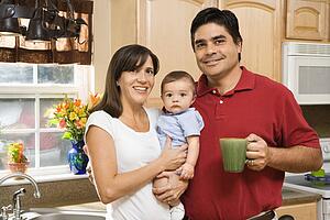 Family portrait in home kitchen with baby
