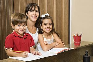 Mother and children smiling with homework