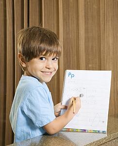 Boy holding up homework