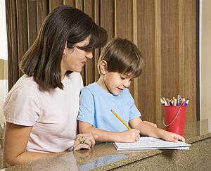 Mother helping son with homework
